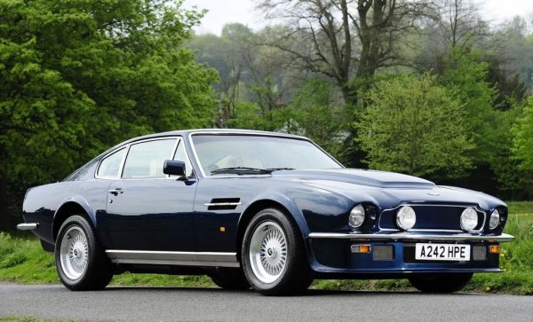 Покрай по-съвременните версии на Vantage, у нас е внесена и една бройка от оригиналния гранд турър от 70-те години - любимата кола на Дейвид Бекъм, ако се вярва на таблоидите. Този автомобил е лансиран през 1977 като "първата британска суперкола". Това не е чак такова преувеличение, защото показателите са впечатляващи за епохата: 270 км/ч максимална скорост и 5.3 секунди от място до 100 км/ч. Това е всъщност по-бързо от Ferrari Daytona. Двигателят, в зависимост от годината, е или 5.3-литров, или 6.3-литров V8. От този автомобил са построени само 534 бройки, цената започва над 150,000 евро. 
