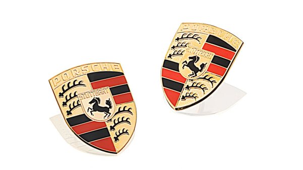 Първият опит Porsche да се сдобие с герб е чрез открит конкурс. През март 1951 г. лекарят и колекционер на произведения на изкуството от Щутгарт, Отомар Домник, провежда конкурс в германски художествени академии. Наградата, предложена за създаване на лого, е 1000 германски марки. Нито един от представените дизайни обаче не отговаря на замисъла на ръководството на Porsche.
