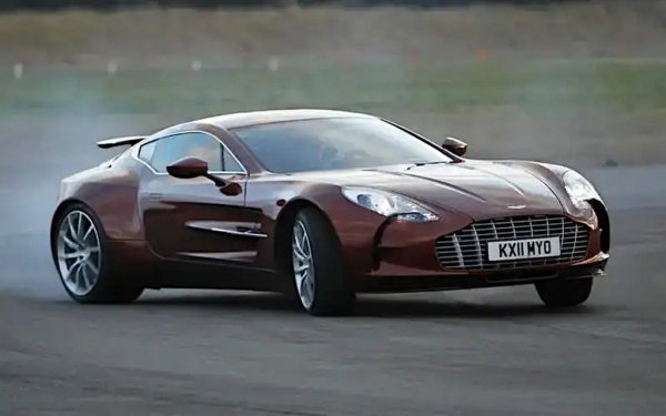 Aston Martin V12, използван за първи път в DB7 през 1999, има дизайн, близък до този на 3,0-литровия Duratec V6, до голяма степен защото датира от епохата, когато марката бе собственост на Ford. 
По време на програма за развитие, предприета от Cosworth, този двигател достигна 7312 куб. см и, във варианта си за специалния One-77, произвежда 750 коня. Среща се и в още по-редкия Victor, където конете вече са 836.
